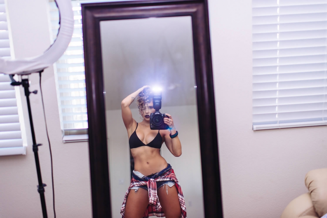 Tianna Gregory in a bikini taking a selfie