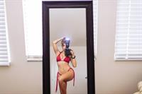 Tianna Gregory in a bikini taking a selfie