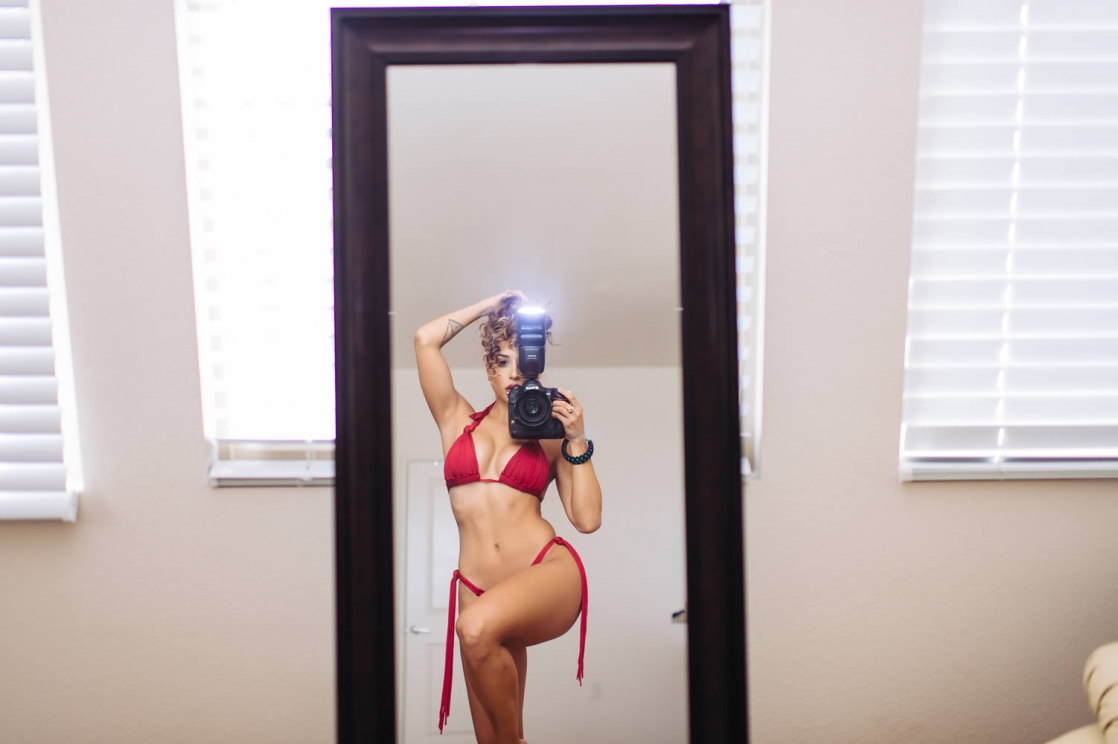 Tianna Gregory in a bikini taking a selfie