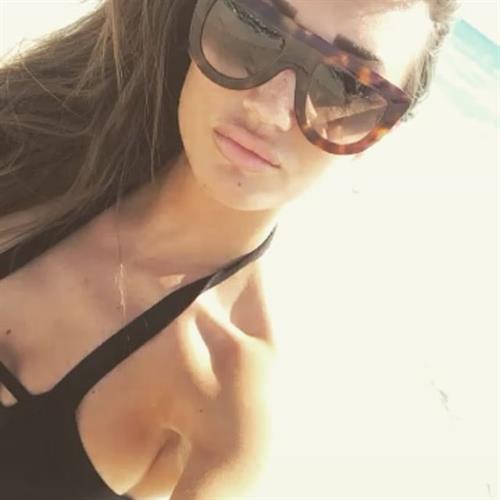 Megan McKenna in a bikini taking a selfie