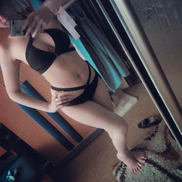 Denika Kiomi in a bikini taking a selfie