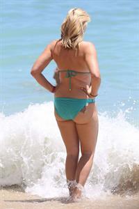 Natasha Henstridge in a bikini - ass