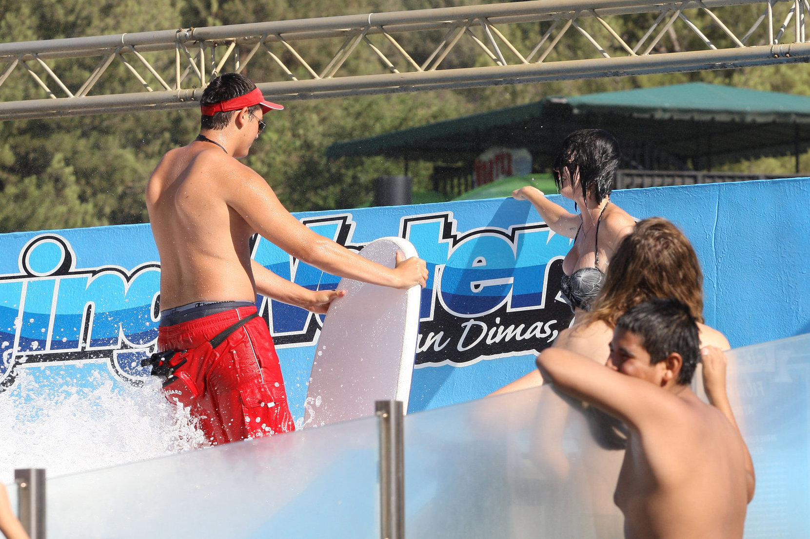 Katy Perry talks with a group of her friends after spending the afternoon at Raging Waters in San Dimas, California on August 12, 2012