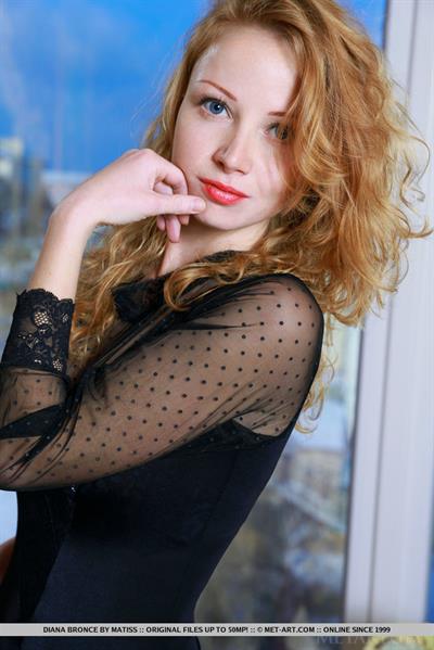 Diana Bronce flaunts her slender body with curvy hips and sexy legs as she poses on the elegant chair.