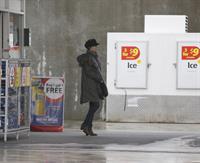 Dannii Minogue - Pictured getting a little wet while filling up on petrol - 09th August 2012
