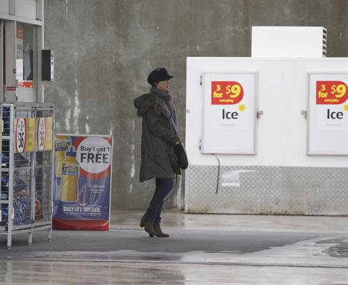 Dannii Minogue - Pictured getting a little wet while filling up on petrol - 09th August 2012