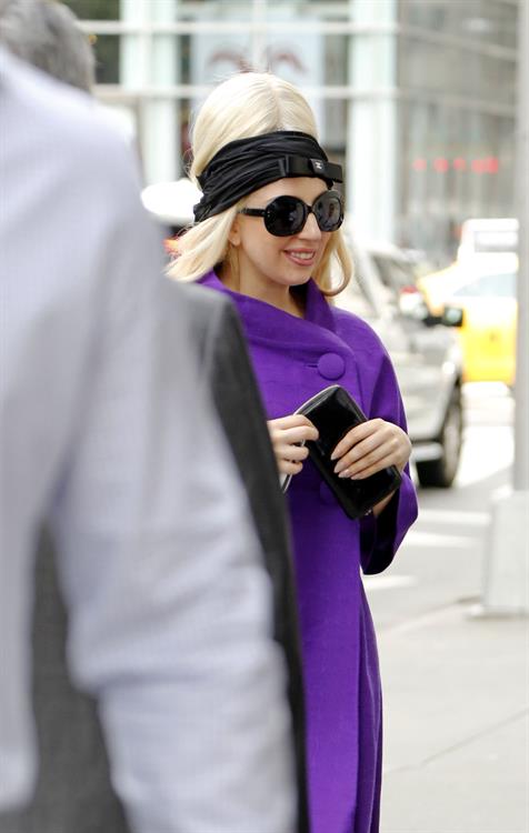 Lady Gaga holds her latest Vogue magazine cover September 2012 Issue close to her chest while out in New York City to visit a friend (07 August 2012).