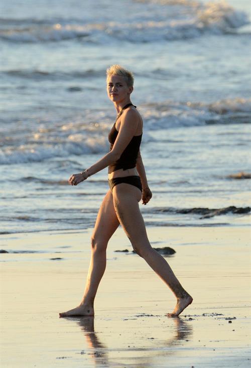 Miley Cyrus  yoga in black bikini on beach in Hawaii 1/24/13 