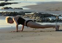 Miley Cyrus  yoga in black bikini on beach in Hawaii 1/24/13 