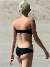 Miley Cyrus  yoga in black bikini on beach in Hawaii 1/24/13 