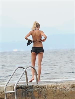 Kimberley Garner in a black bikini on the beach in St. Tropez on July 31, 2014