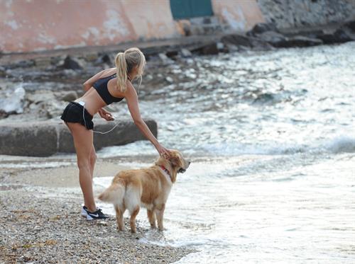 Kimberley Garner in a black bikini on the beach in St. Tropez on July 31, 2014