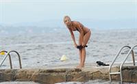 Kimberley Garner in a black bikini on the beach in St. Tropez on July 31, 2014