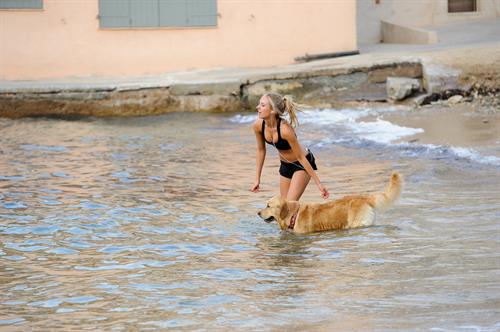 Kimberley Garner in a black bikini on the beach in St. Tropez on July 31, 2014