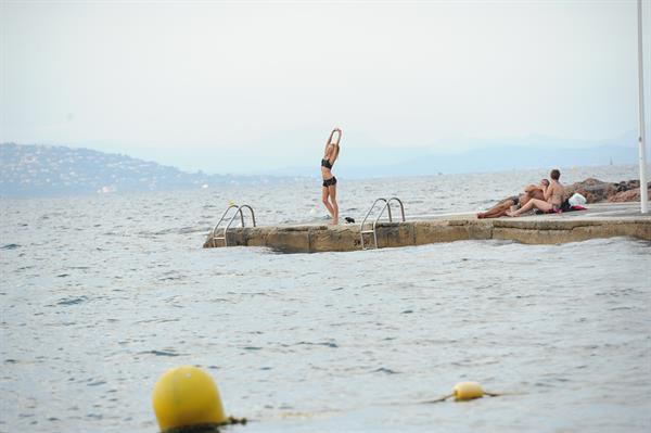 Kimberley Garner in a black bikini on the beach in St. Tropez on July 31, 2014