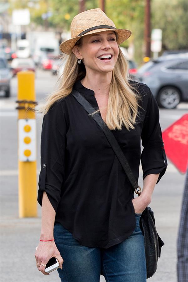 Julie Benz walking in jeans and a hat