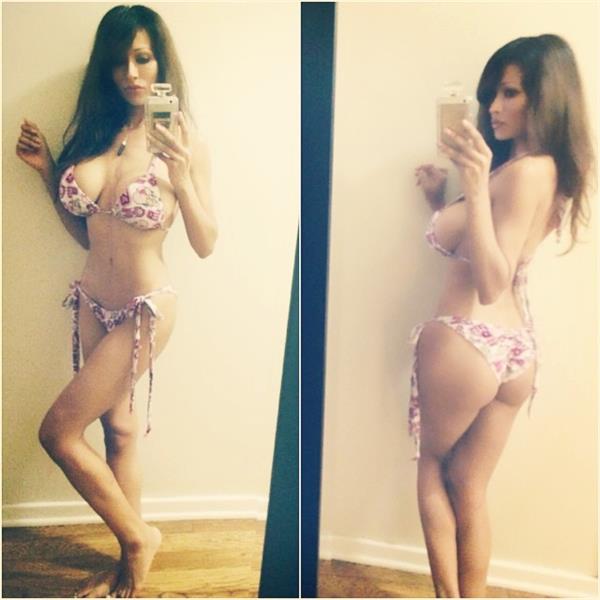 Minnie Gupta in a bikini taking a selfie