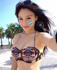 Fan Ling in a bikini taking a selfie