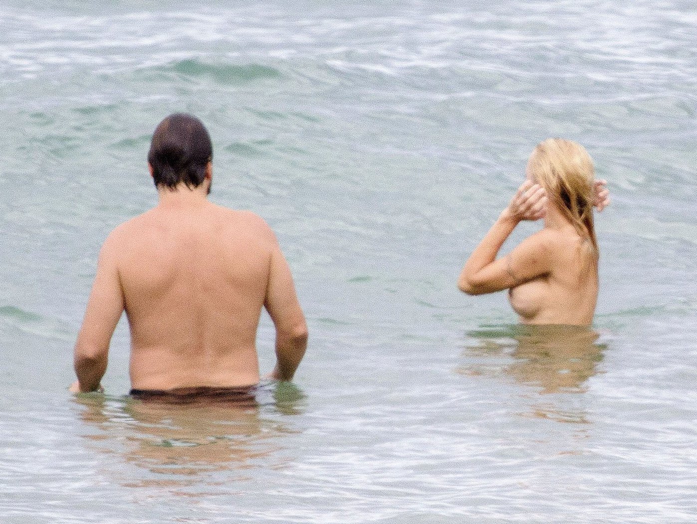 Pamela Anderson Pamela Anderson Going topless at the beach in France 02.10.13