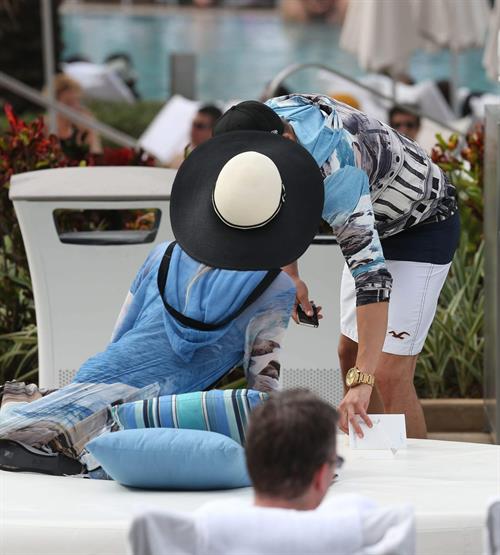 Paris Hilton spends the day in and out of the pool in Miami December 8, 2012