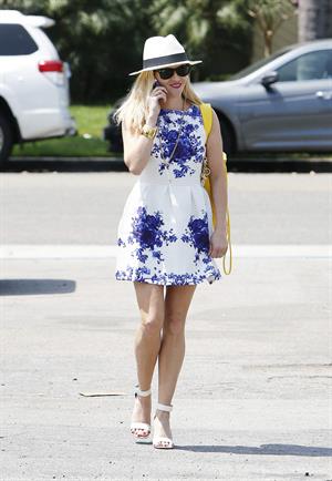 Reese Witherspoon talking and walking after leaving a hair salon in Beverly Hills on August 8, 2014