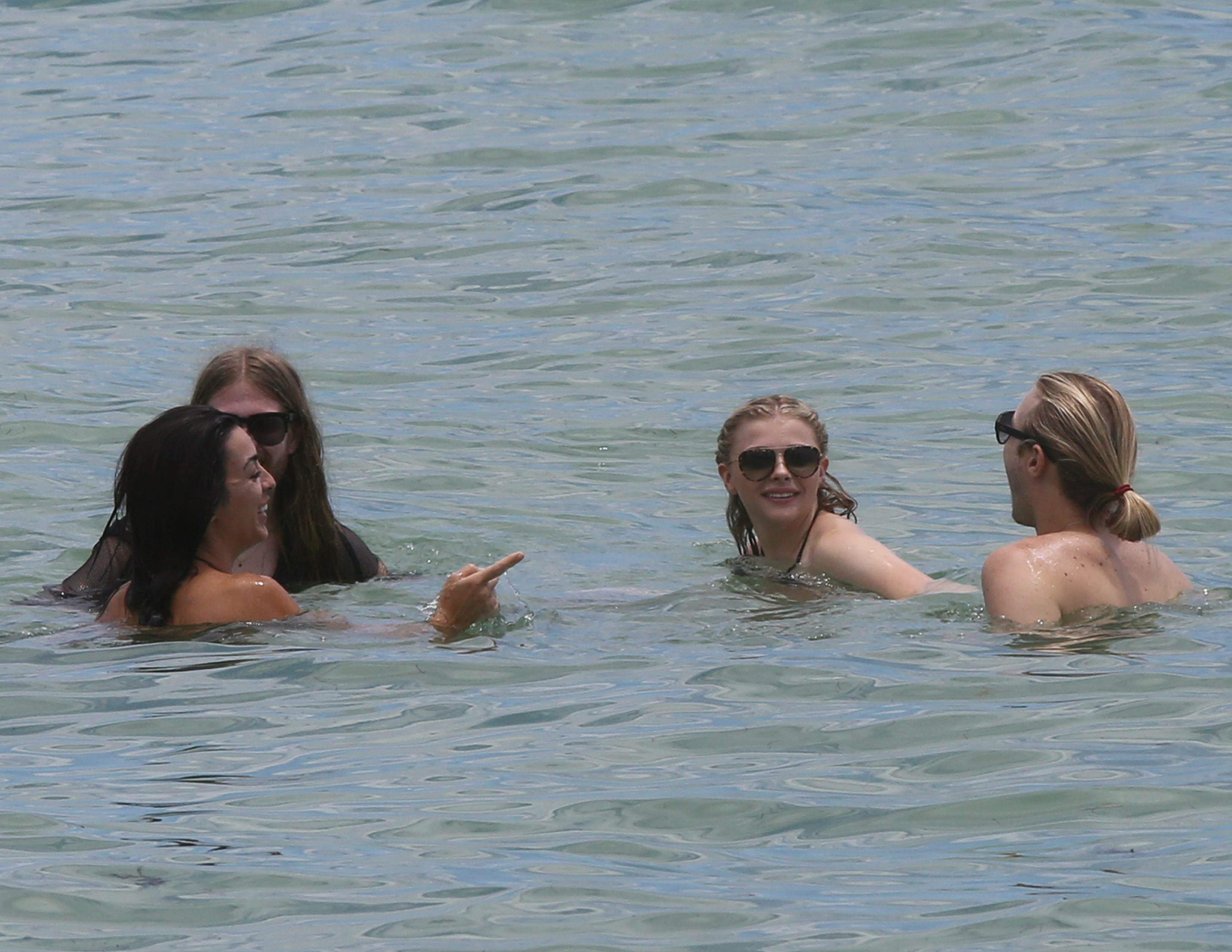 Chloe Grace Moretz candids in a Black Bikini in Miami Beach