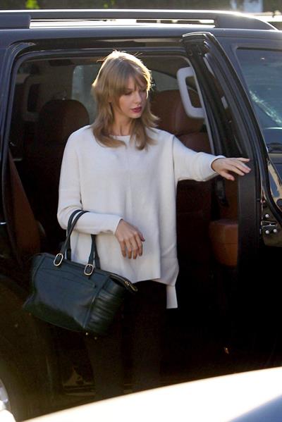 Taylor Swift wearing a white top and black pants in Los Angeles 10/28/13  