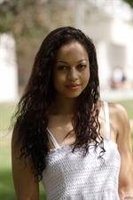 Busty Karissa Kane poses nude in the grass