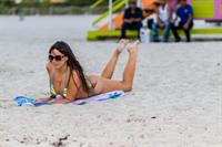 Claudia Romani sexy doing yoga at the beach in a thong bikini showing off her boobs and ass seen by paparazzi.




















