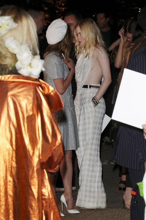 Ellie Bamber Pictures Ellie Bamber braless boobs while wearing basically a scarf as a top showing side boob cleavage.