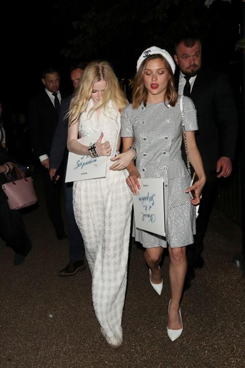 Ellie Bamber Pictures Ellie Bamber braless boobs while wearing basically a scarf as a top showing side boob cleavage.