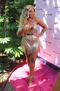 Ashanti Pictures Ashanti sexy cleavage in a low cut dress at the PrettyLittleThings launch party.