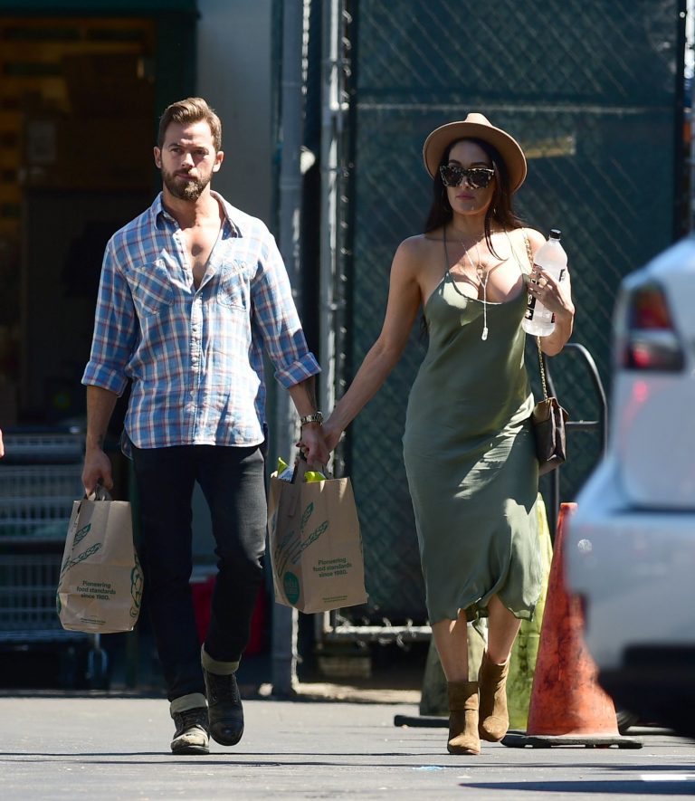 Nikki Bella Pictures Nikki Bella braless boobs in a green dress seen by paparazzi.
