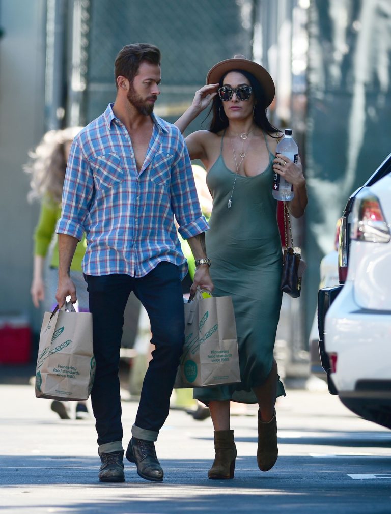 Nikki Bella Pictures Nikki Bella braless boobs in a green dress seen by paparazzi.