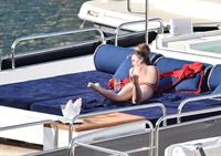 Chrissy Teigen sexy cleavage and ass in a swimsuit with her husband John Legend seen by paparazzi.
