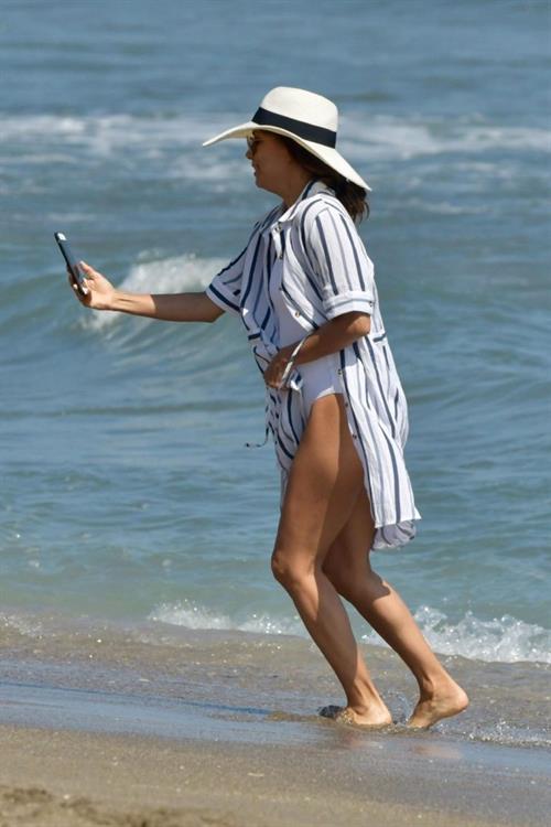 Eva Longoria Bikini Pictures Eva Longoria sexy ass in a swimsuit at the beach seen by paparazzi.