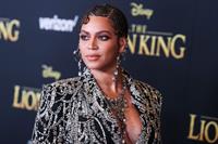 Beyonce braless boobs and areola peek showing off nice cleavage on the red carpet for the premiere of  The Lion King .







