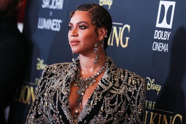 Beyonce braless boobs and areola peek showing off nice cleavage on the red carpet for the premiere of  The Lion King .






