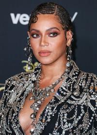 Beyonce braless boobs and areola peek showing off nice cleavage on the red carpet for the premiere of  The Lion King .






