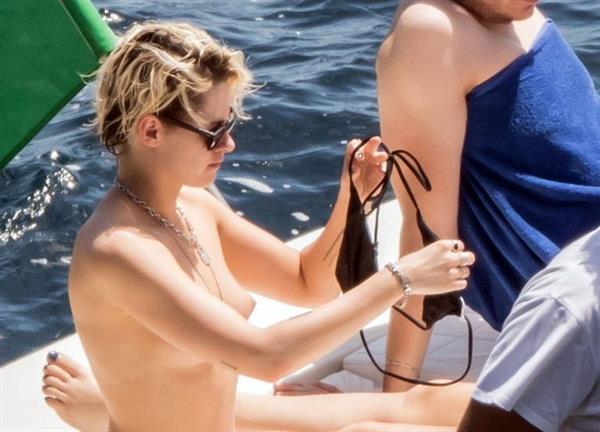 Kristen Stewart nude boobs caught topless by paparazzi tanning on a boat.
