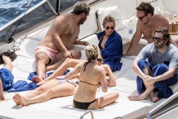 Kristen Stewart nude boobs caught topless by paparazzi tanning on a boat.
