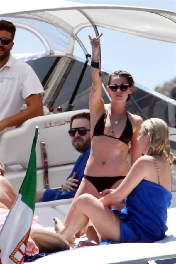 Kristen Stewart nude boobs caught topless by paparazzi tanning on a boat.
