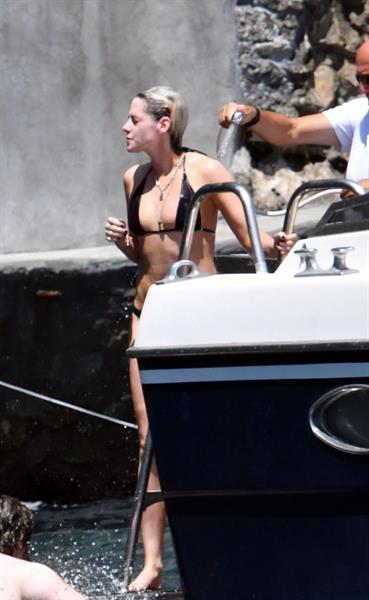 Kristen Stewart nude boobs caught topless by paparazzi tanning on a boat.
