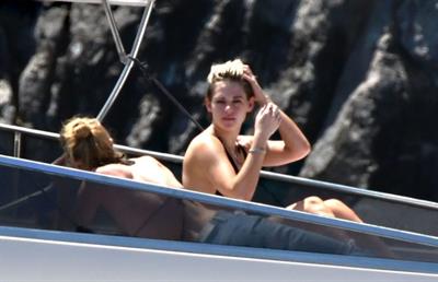 Kristen Stewart nude boobs caught topless by paparazzi tanning on a boat.
