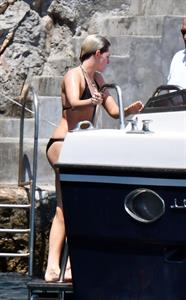 Kristen Stewart nude boobs caught topless by paparazzi tanning on a boat.
