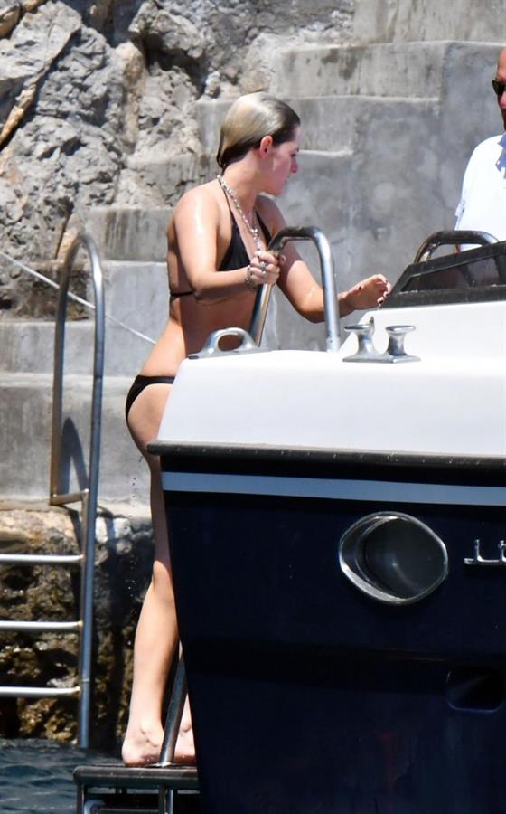 Kristen Stewart nude boobs caught topless by paparazzi tanning on a boat.
