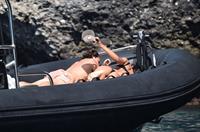 Madalina Diana Ghenea sexy ass and cleavage in a thong bikini seen by paparazzi.


