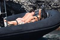 Madalina Diana Ghenea sexy ass and cleavage in a thong bikini seen by paparazzi.


