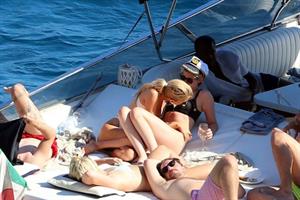 Kristen Stewart and Stella Maxwell sexy lesbians making out on a boat in bikinis seen by paparazzi.










