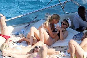Kristen Stewart and Stella Maxwell sexy lesbians making out on a boat in bikinis seen by paparazzi.










